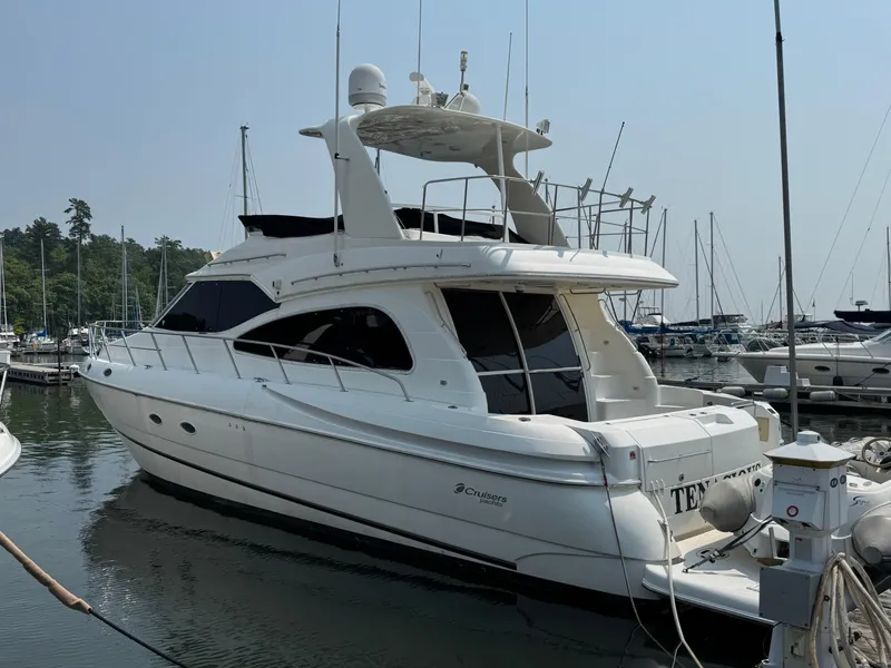 Slide: The Image of 2003 Cruisers Yachts 5000 Sedan Sport docked at marina, side view. - 2