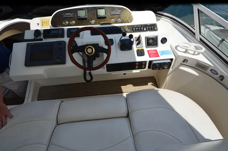 Slide: The Image of 2003 Cruisers Yachts 5000 Sedan Sport helm with steering wheel and navigation controls. - 20