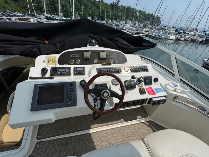 Slide: The Image of Helm of 2003 Cruisers Yachts 5000 Sedan Sport with navigation equipment and steering wheel. - 21
