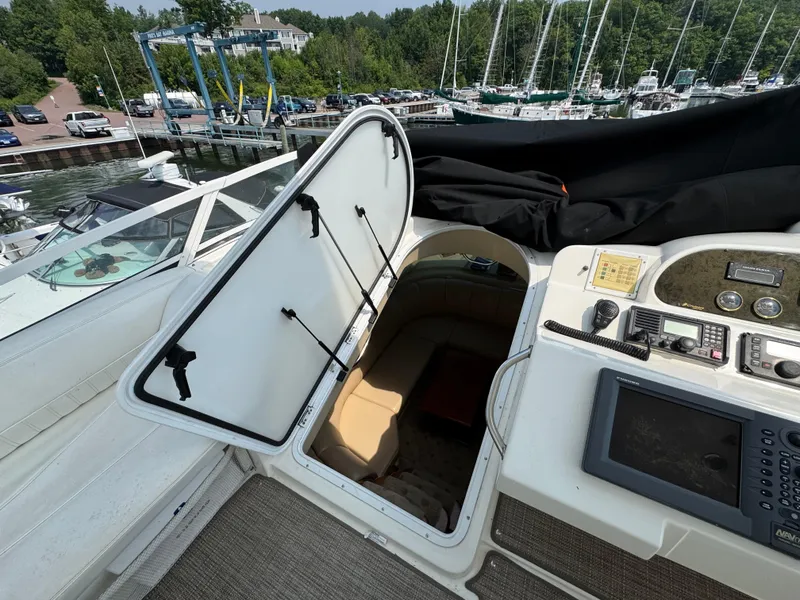 Slide: The Image of 2003 Cruisers Yachts 5000 Sedan Sport interior view with open hatch and control panel. - 24