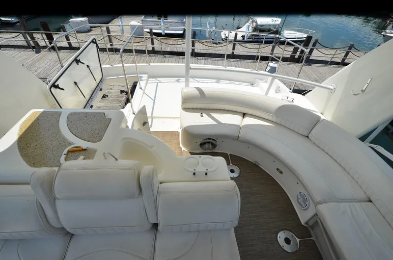 Slide: The Image of 2003 Cruisers Yachts 5000 Sedan Sport interior with white seating and deck view. - 25
