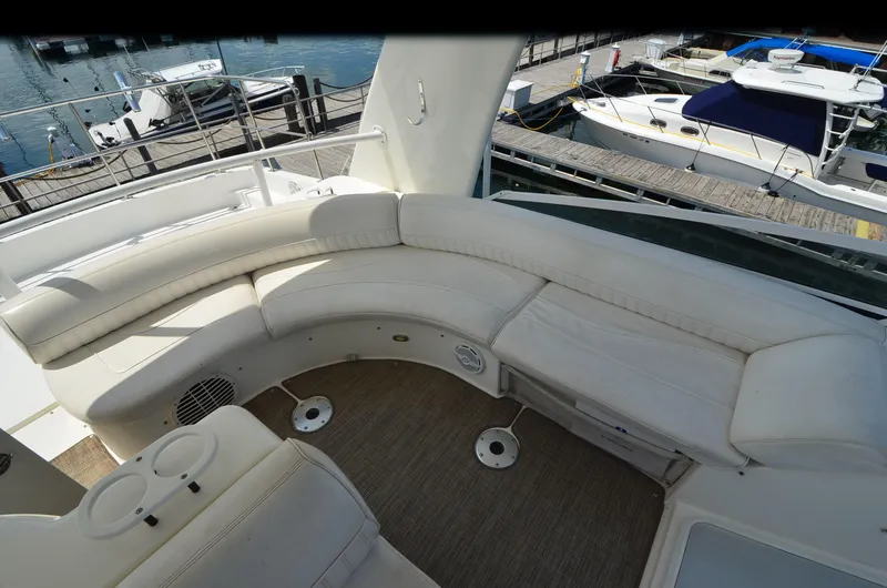 Slide: The Image of 2003 Cruisers Yachts 5000 Sedan Sport interior with white seating and marina view. - 26