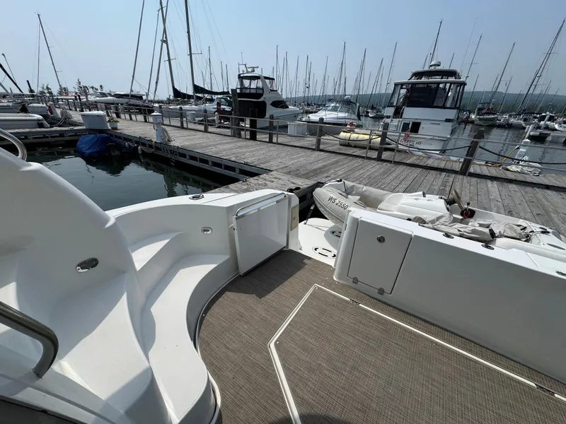 Slide: The Image of 2003 Cruisers Yachts 5000 Sedan Sport docked at marina with other boats. - 29