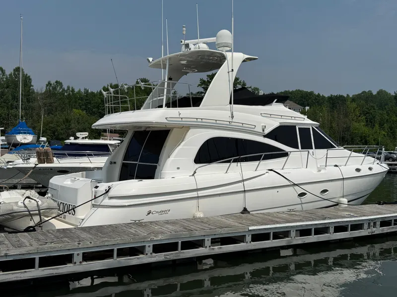 Slide: The Image of 2003 Cruisers Yachts 5000 Sedan Sport docked at marina, side view. - 3