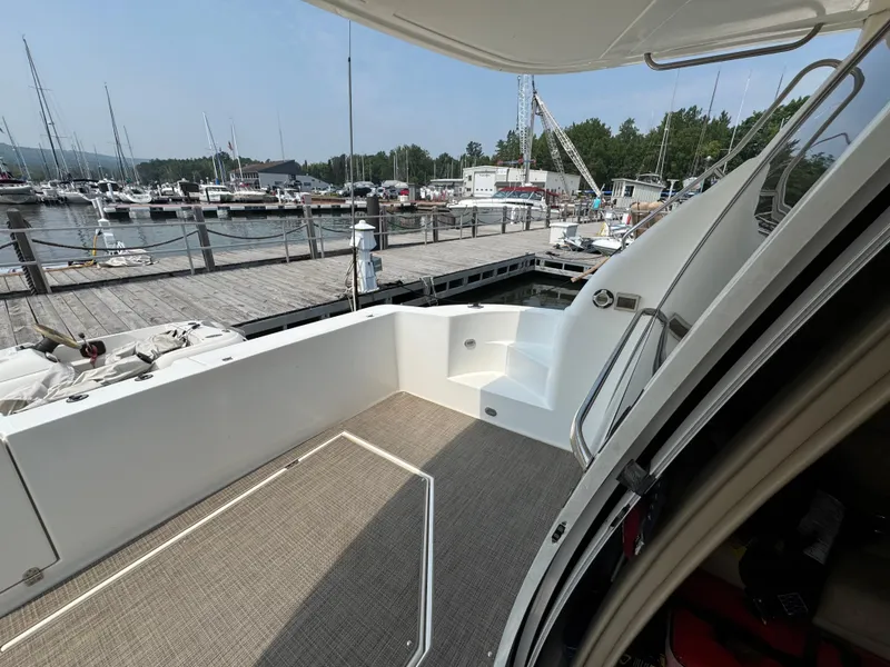 Slide: The Image of 2003 Cruisers Yachts 5000 Sedan Sport docked at marina, showing deck and stairs. - 30