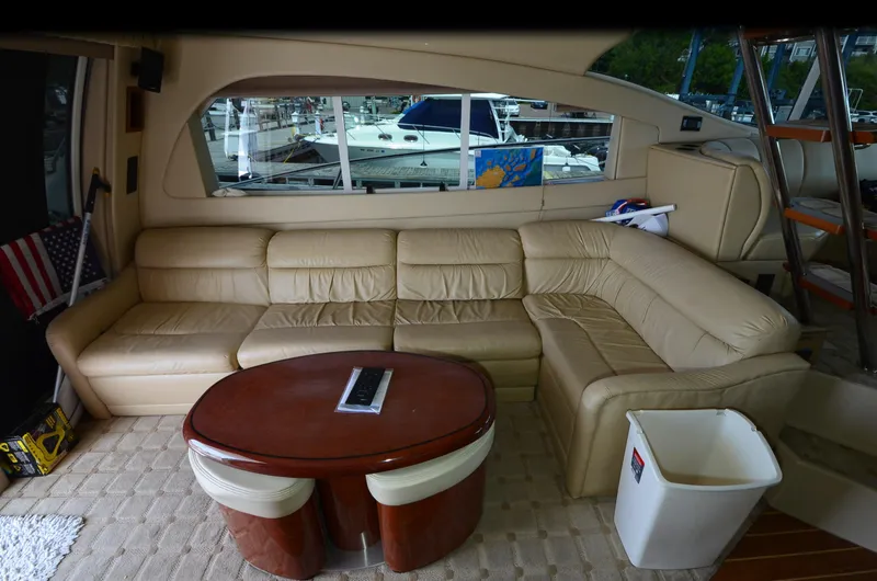 Slide: The Image of Luxurious interior of 2003 Cruisers Yachts 5000 Sedan Sport with leather seating and wooden table. - 35