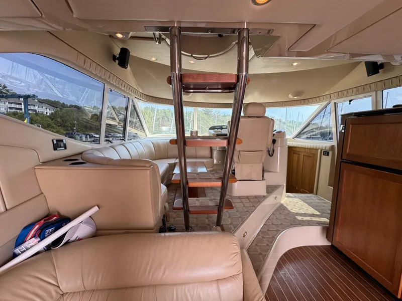 Slide: The Image of Luxurious interior of 2003 Cruisers Yachts 5000 Sedan Sport with leather seating and wooden accents. - 40