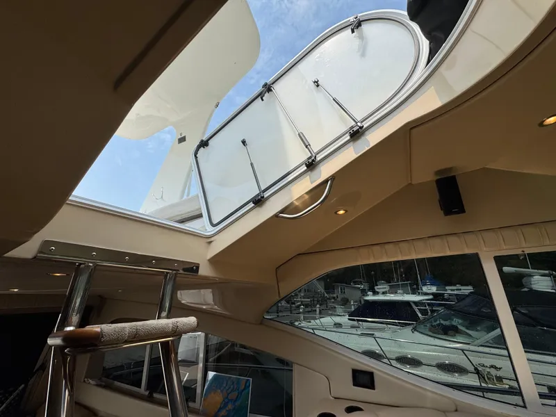 Slide: The Image of Interior view of 2003 Cruisers Yachts 5000 Sedan Sport, featuring open hatch and ladder. - 43