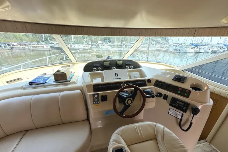 Slide: The Image of 2003 Cruisers Yachts 5000 Sedan Sport helm with marina view. - 45