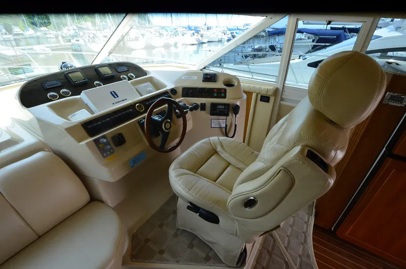 Slide: The Image of 2003 Cruisers Yachts 5000 Sedan Sport helm with leather captain's chair and control panel. - 46