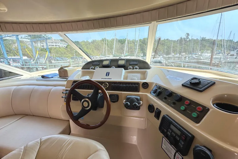 Slide: The Image of 2003 Cruisers Yachts 5000 Sedan Sport helm with steering wheel and control panel. - 48