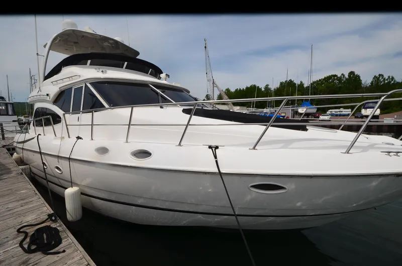 Slide: The Image of 2003 Cruisers Yachts 5000 Sedan Sport docked at marina. - 5