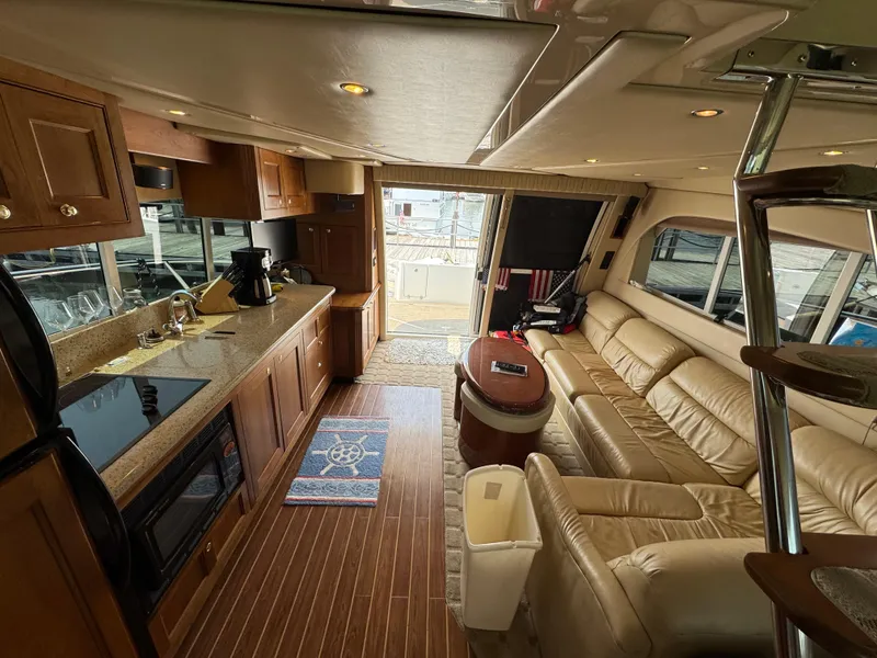 Slide: The Image of Luxurious interior of 2003 Cruisers Yachts 5000 Sedan Sport with kitchen and seating area. - 51