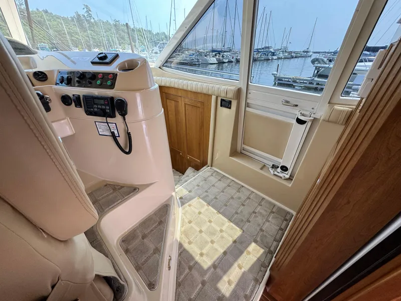 Slide: The Image of Interior helm of 2003 Cruisers Yachts 5000 Sedan Sport, overlooking marina. - 53