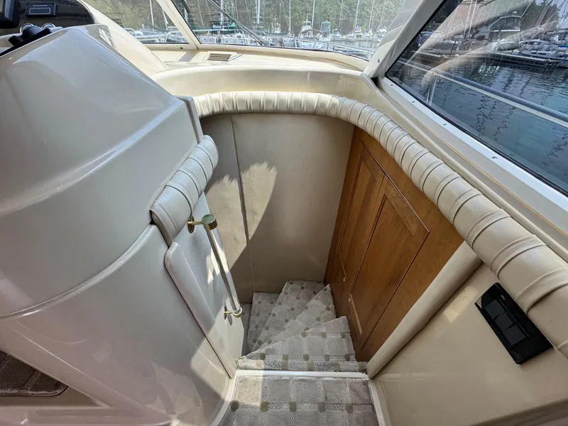 Slide: The Image of Interior stairs of 2003 Cruisers Yachts 5000 Sedan Sport, featuring elegant design and wood accents. - 56