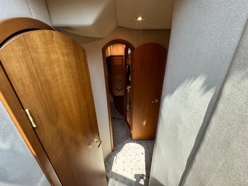 Slide: The Image of Interior hallway of 2003 Cruisers Yachts 5000 Sedan Sport with wooden doors. - 57