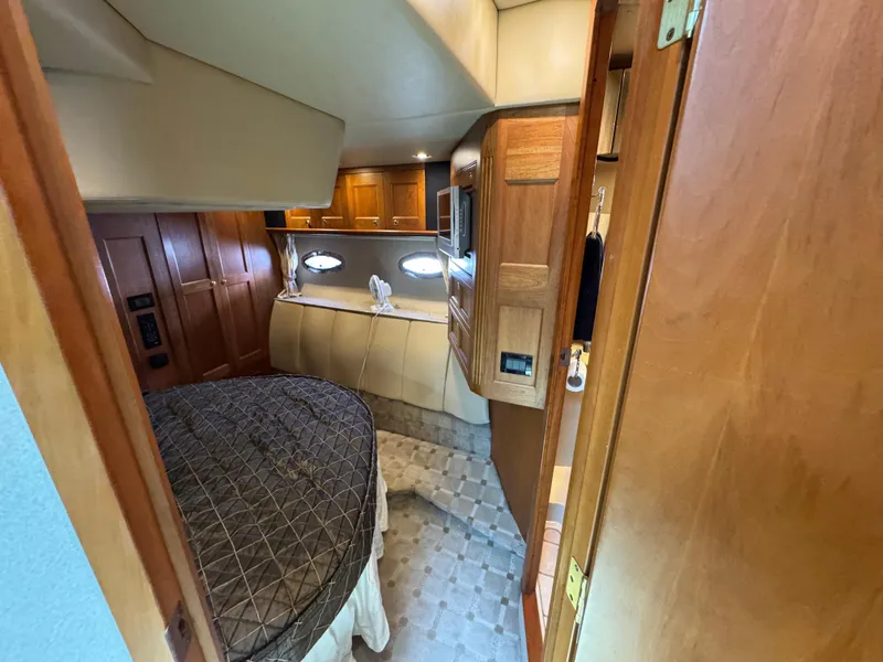 Slide: The Image of 2003 Cruisers Yachts 5000 Sedan Sport cabin interior with bed and wooden cabinetry. - 58
