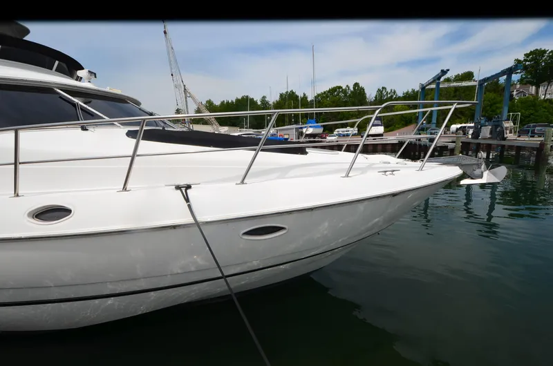 Slide: The Image of 2003 Cruisers Yachts 5000 Sedan Sport docked at marina, side view. - 6