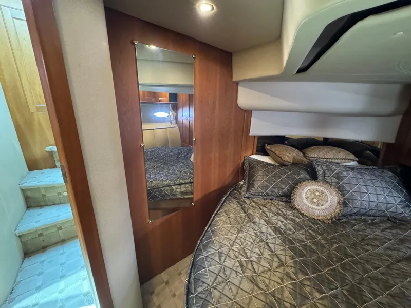 Slide: The Image of Luxurious bedroom interior of 2003 Cruisers Yachts 5000 Sedan Sport with elegant bedding. - 60