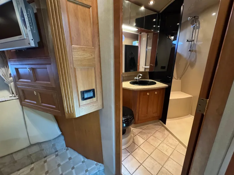 Slide: The Image of 2003 Cruisers Yachts 5000 Sedan Sport interior with bathroom and wooden cabinetry. - 61