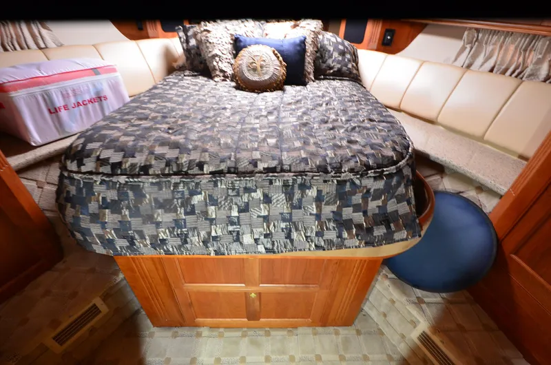 Slide: The Image of Luxurious cabin interior of 2003 Cruisers Yachts 5000 Sedan Sport with cozy bedding. - 67