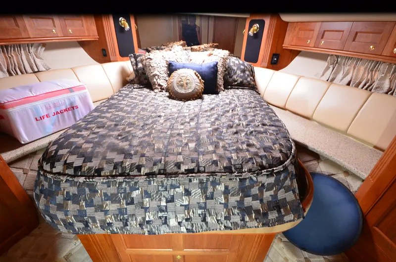Slide: The Image of Luxurious cabin interior of 2003 Cruisers Yachts 5000 Sedan Sport with bed and life jackets. - 68