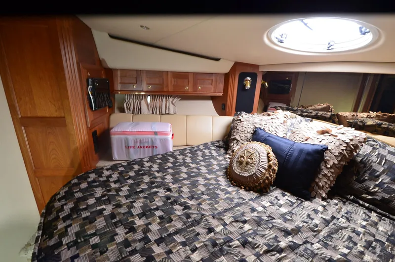 Slide: The Image of Luxurious cabin interior of 2003 Cruisers Yachts 5000 Sedan Sport with stylish bedding. - 70