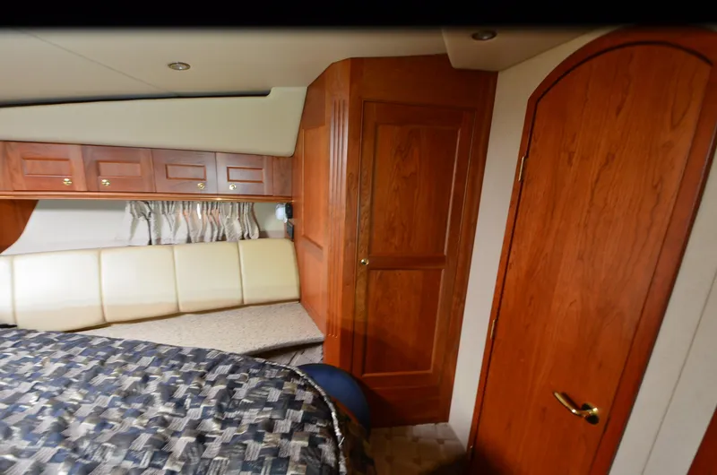 Slide: The Image of Interior of 2003 Cruisers Yachts 5000 Sedan Sport with wood paneling and cozy seating. - 72