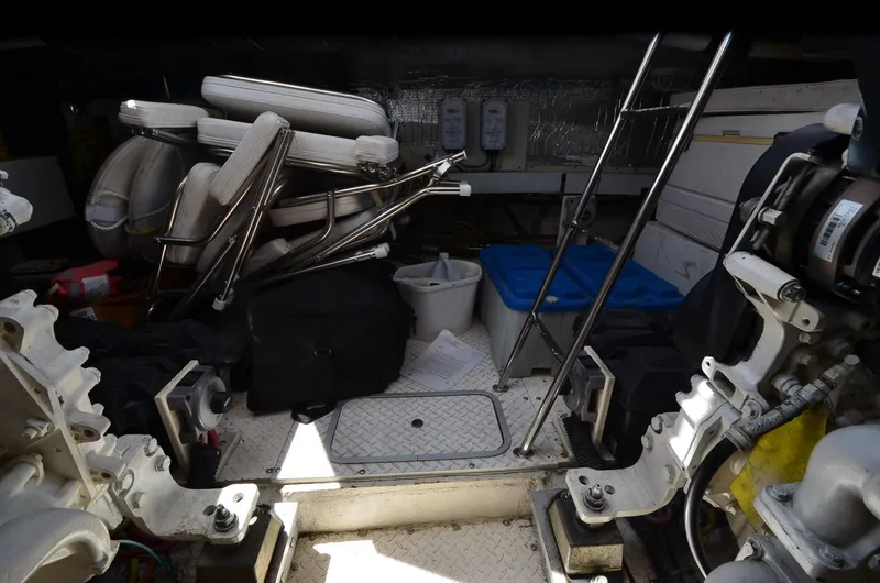 Slide: The Image of Engine room of 2003 Cruisers Yachts 5000 Sedan Sport with stored equipment and ladder. - 88