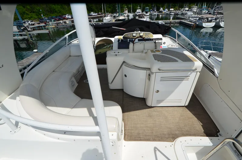 Slide: The Image of 2003 Cruisers Yachts 5000 Sedan Sport interior with seating and helm at marina. - 9