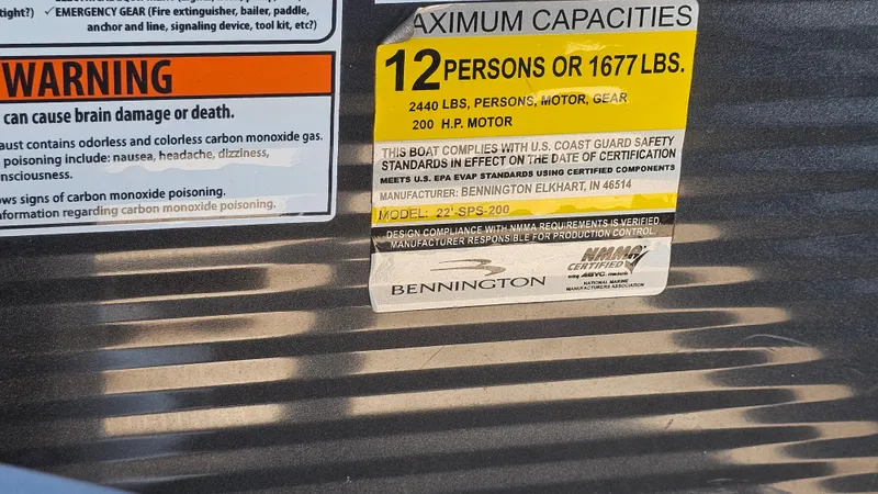 Slide: The Image of 2020 Bennington SX 23 Premium Swingback capacity label, 12 persons or 1677 lbs, 200 HP motor. - 20