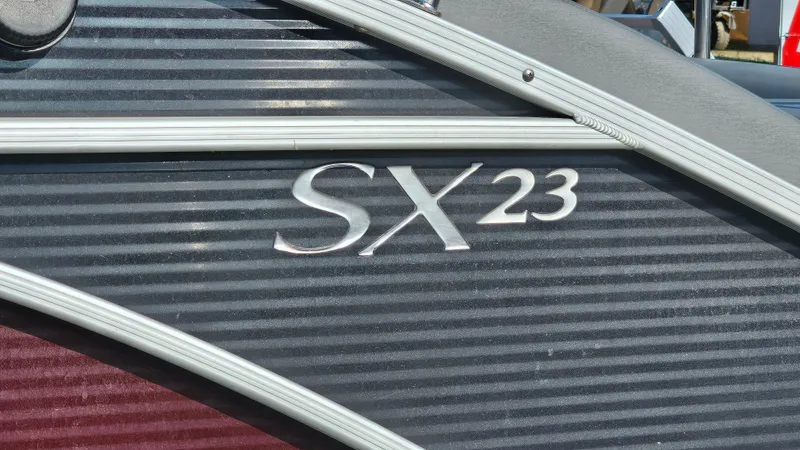 Slide: The Image of 2020 Bennington SX 23 Premium Swingback boat logo on ribbed surface. - 21