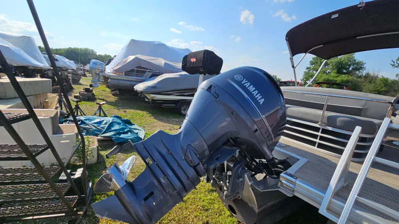 Slide: The Image of 2020 Bennington SX 23 Premium Swingback with Yamaha outboard motor in a boatyard. - 4