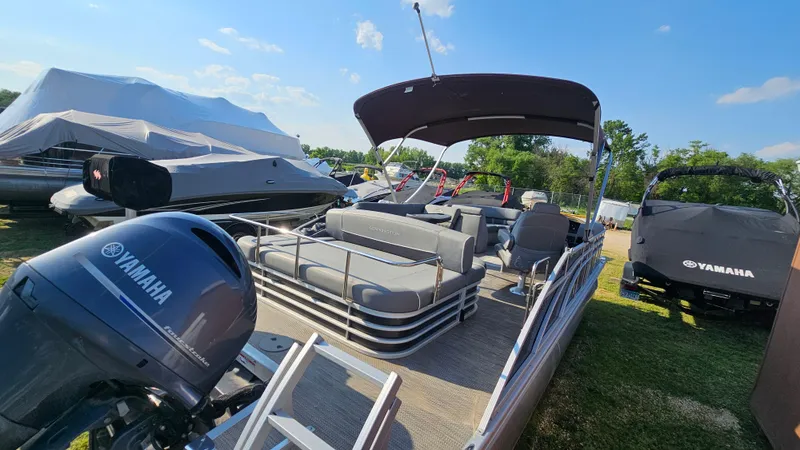 Slide: The Image of 2020 Bennington SX 23 Premium Swingback pontoon boat with Yamaha engine, parked outdoors. - 5