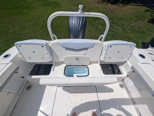 Slide: The Image of 2025 Robalo R207 Dual Console boat interior with storage compartments and seating. - 13