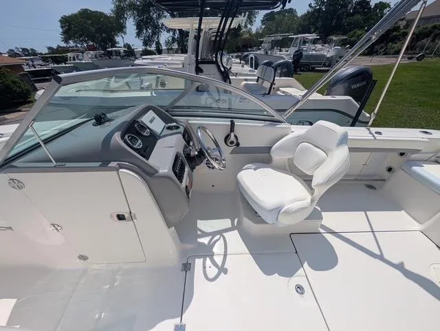 Slide: The Image of 2025 Robalo R207 Dual Console boat interior with steering wheel and seating. - 14