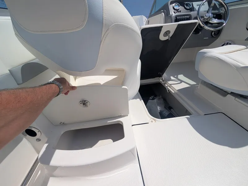 Slide: The Image of 2025 Robalo R207 Dual Console interior with storage compartment and steering wheel. - 5