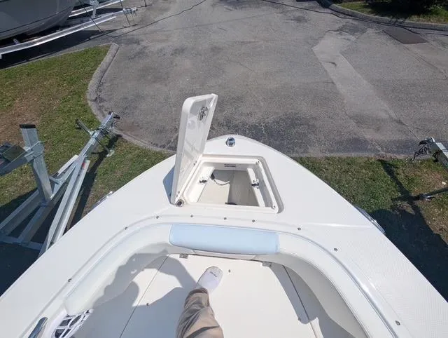 Slide: The Image of 2025 Robalo R207 Dual Console boat with open storage compartment on deck. - 8