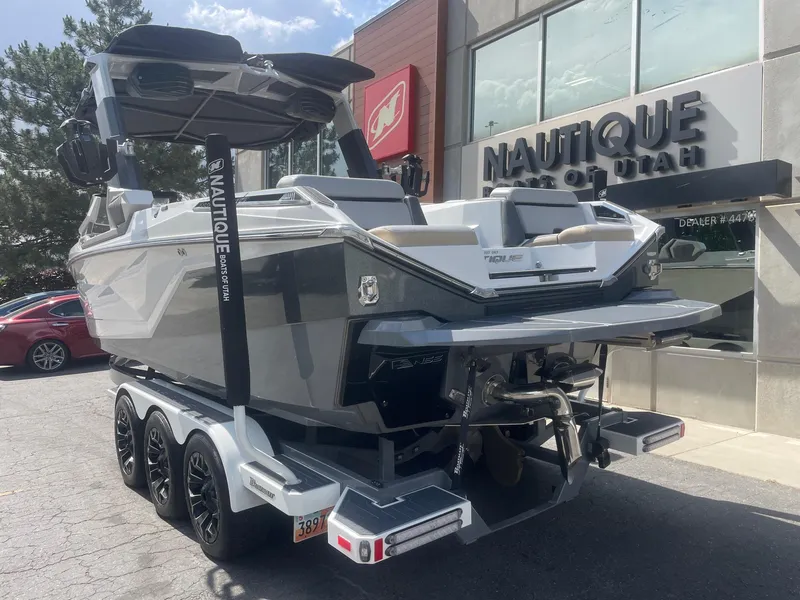 Slide: The Image of 2021 Nautique Super Air Nautique G25 Paragon boat on trailer outside dealership. - 3