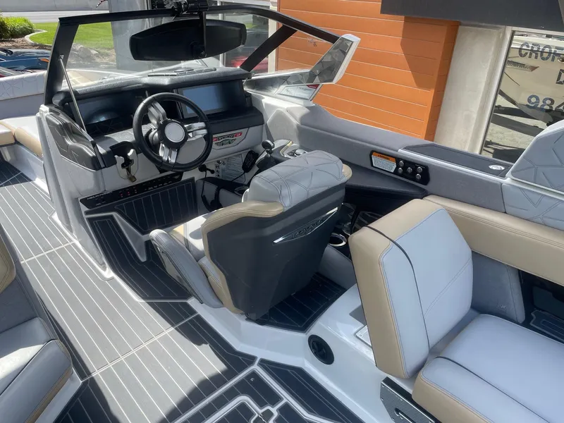 Slide: The Image of 2021 Nautique Super Air Nautique G25 Paragon interior with modern helm and luxurious seating. - 6