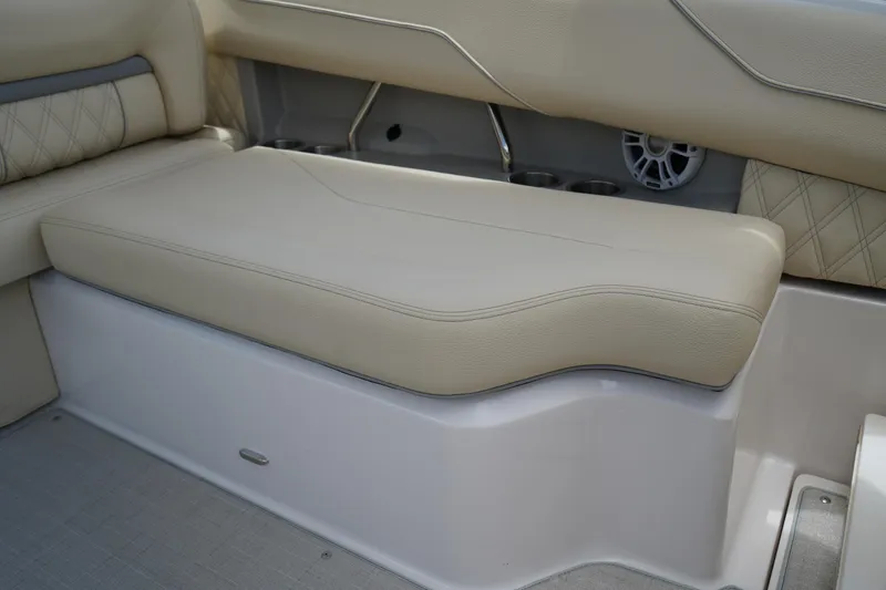 Slide: The Image of 2023 Regal LX4 boat interior with beige cushioned seating and speaker detail. - 13