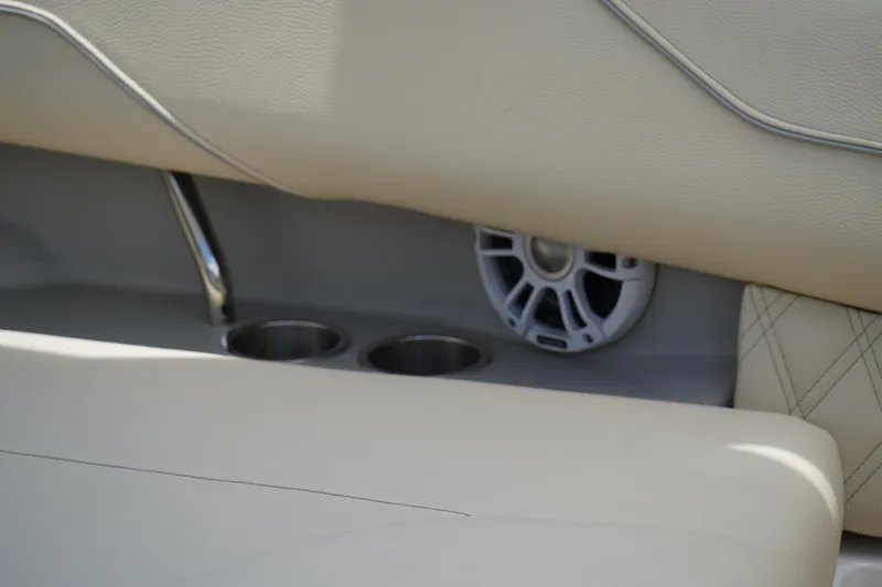 Slide: The Image of 2023 Regal LX4 interior with beige leather seats, cup holders, and speaker detail. - 14