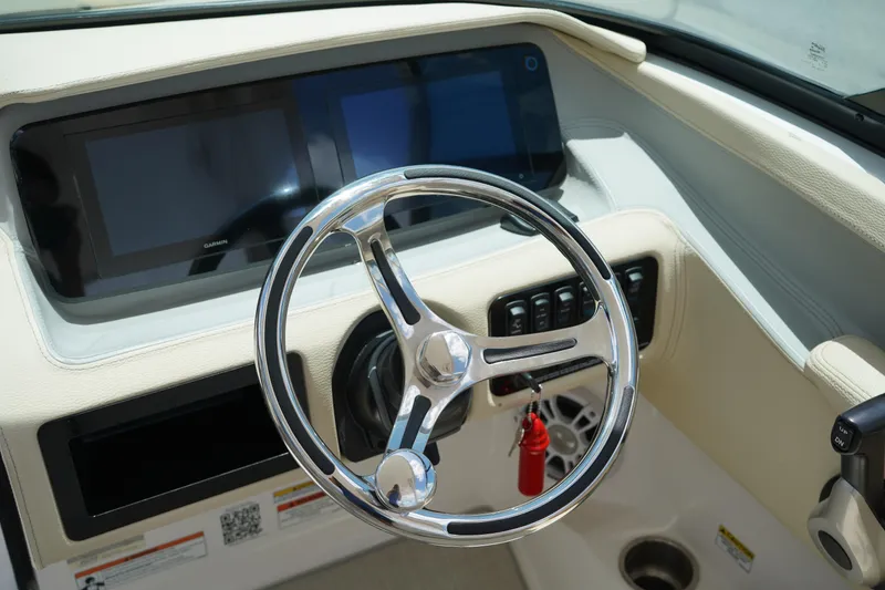 Slide: The Image of 2023 Regal LX4 boat dashboard with modern steering wheel and digital displays. - 23