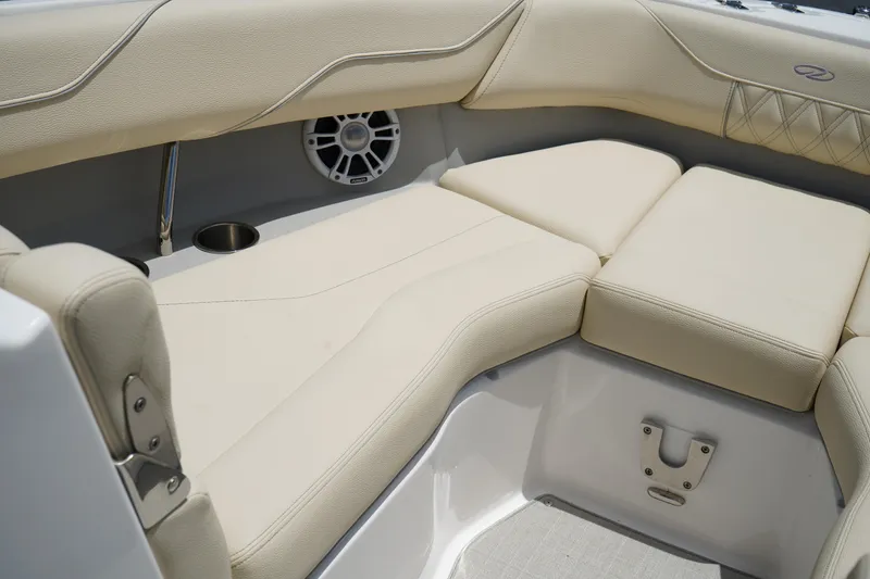 Slide: The Image of 2023 Regal LX4 boat interior with beige cushioned seating and speaker. - 30