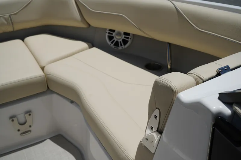 Slide: The Image of Luxurious seating in 2023 Regal LX4 boat with beige upholstery and speaker detail. - 32