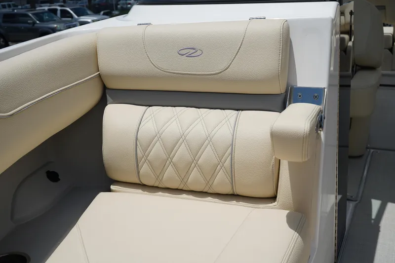Slide: The Image of Luxurious beige seating on 2023 Regal LX4 boat, featuring diamond stitching and armrest. - 36