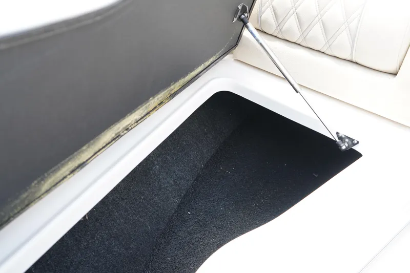 Slide: The Image of 2023 Regal LX4 storage compartment with open lid and black interior. - 37