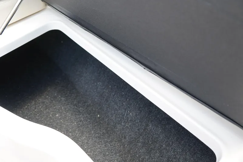 Slide: The Image of 2023 Regal LX4 storage compartment with black interior and white trim. - 40