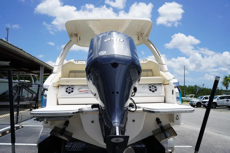 Slide: The Image of 2023 Regal LX4 boat with powerful outboard motor, parked under a clear blue sky. - 6