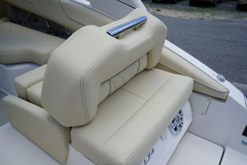Slide: The Image of 2023 Regal LX4 boat with beige leather seating and chrome handle. - 9